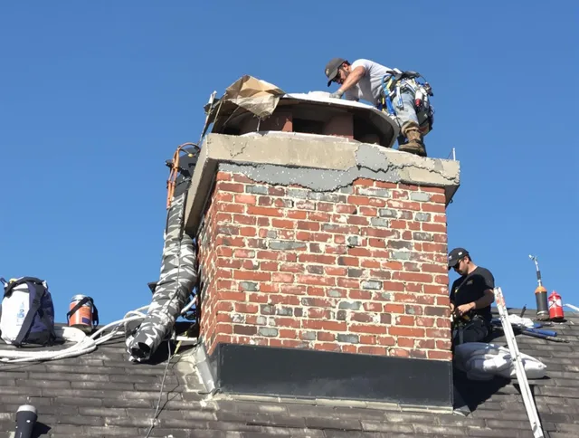 Sudbury Chimney Sweep installing a custom chimney crown in Sudbury, MA